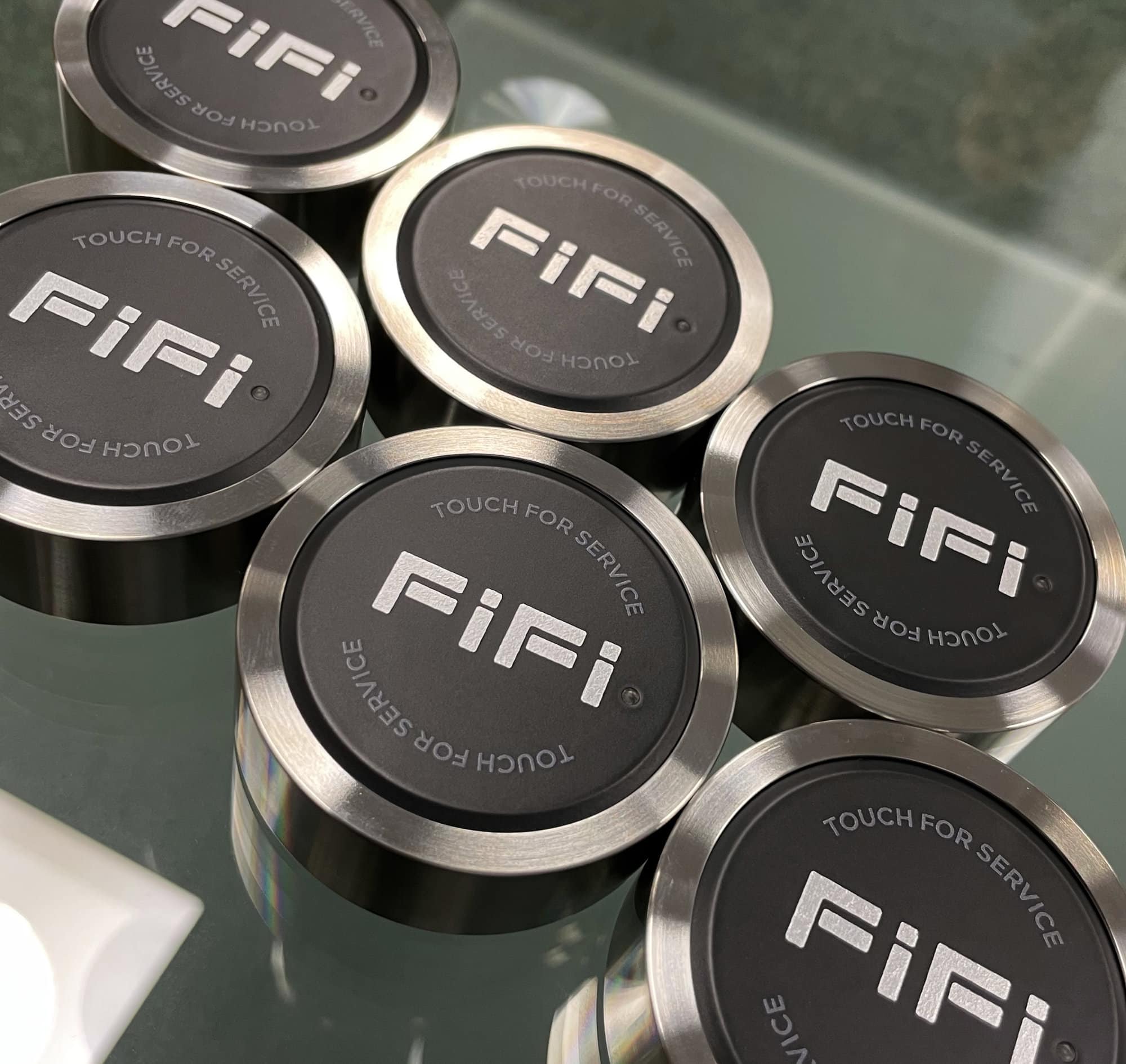 Group of customised Dinggly OneTouch Halo call buttons with FiFi superyacht graphics